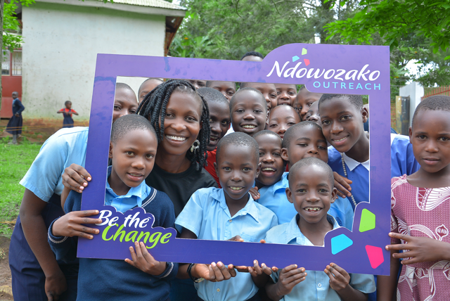 Volunteers and children holding the Ndowozako frame